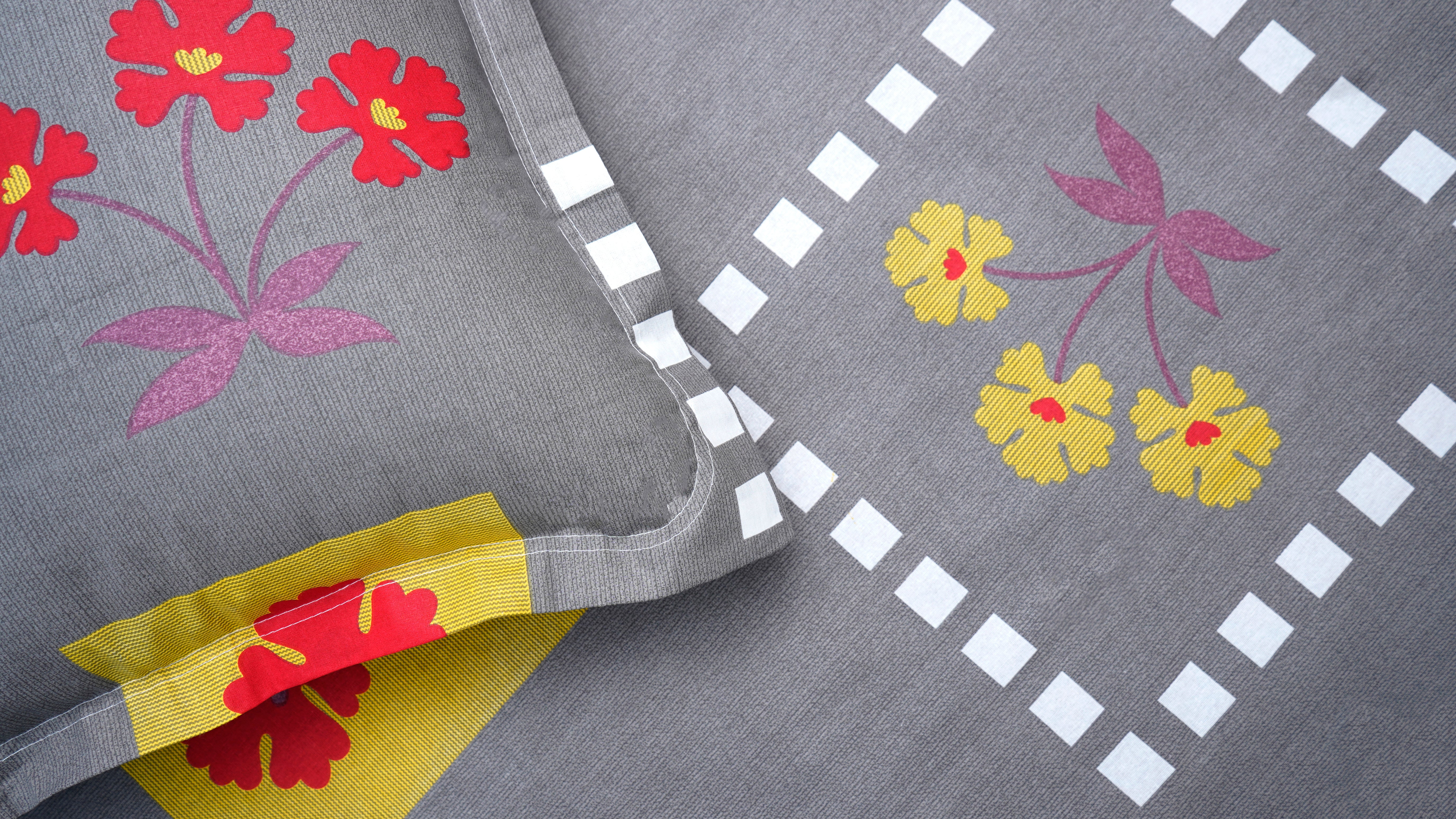 Dark grey with playful red and yellow flowers double bedsheet with pillow covers