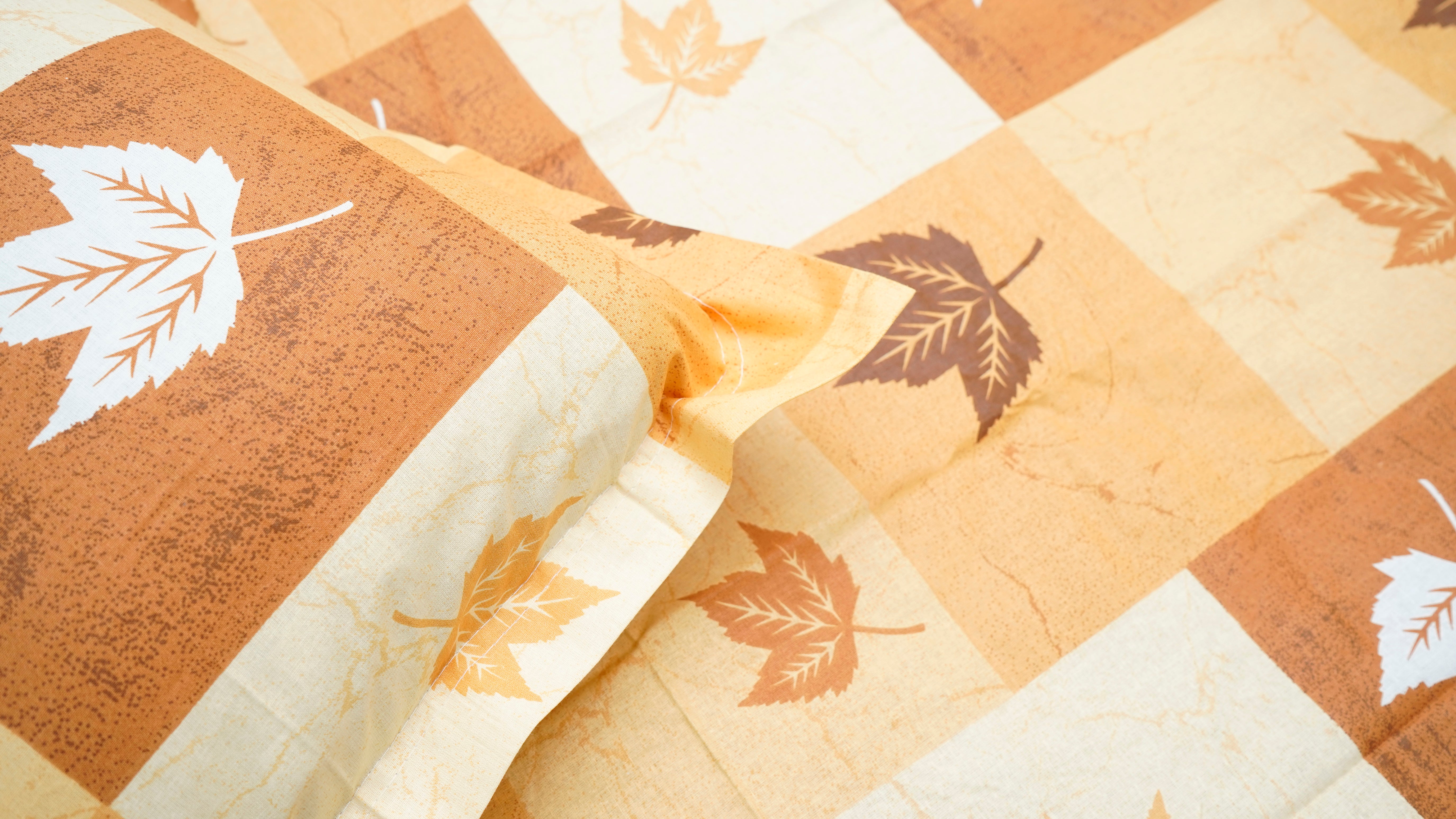 Brown shaded checks with maple prints double bedsheet with pillow covers